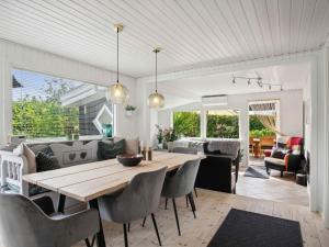 a dining room and living room with a table and chairs at 5 star holiday home in Karrebæksminde in Karrebæksminde +26 photos