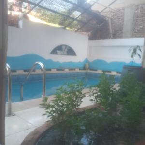 a swimming pool in a building with a swimming pool at Memnoun house in Luxor