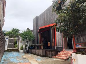 a building with a red front door and stairs at Hanok Stay Chunhwadang in Mokpo