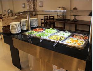 a buffet line with many different types of food at Ágape Hotel De Aparecida in Aparecida