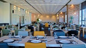 a dining room with tables and chairs in a room with at Golden Tulip Ever Yongin Hotel in Tugyeul