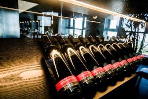 a row of wine bottles lined up on a shelf at Grand Hillstone Hotel in Hyoja-dong