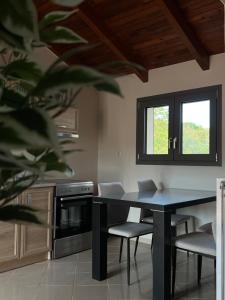 a kitchen with a table and chairs and a window at Entire Apartment 140m2 near Syvota and Parga in Makrochóra