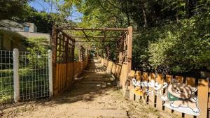an entrance to a fence with graffiti on it at Glamdog Dog Pension Cheongpyeong Branch in Gapyeong