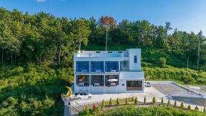 a house with a car parked in front of it at Yeosu Road 328 Ocean View Pool Villa in P'yongsa-ri +23 photos