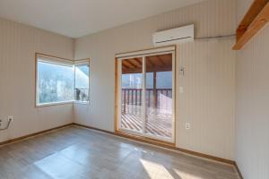 an empty room with a large window and a balcony at Hwasun Byeolsan Pension in Wajun