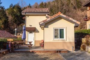 a small house with a picnic table and a patio at Hwasun Byeolsan Pension in Wajun +12 photos