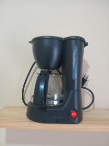 a black blender sitting on top of a shelf at Casa em Nova Iguaçu in Nova Iguaçu +10 photos