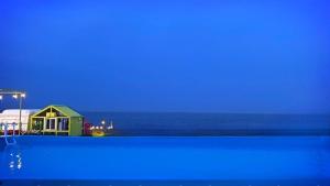 a view of a house and the ocean at night at Pohang Unis Sea Caravan Guryongpo Branch in Saegi