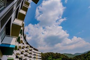 a building with balconies on the side of it at Pyeongchang I-One Resort in Pyeongchang