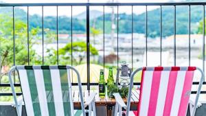 a table with two chairs and two bottles on it at Glamdog Dog Pension Tongyeong Branch in Wŏnmul-li +19 photos