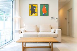 a living room with a couch and a coffee table at Yangyang Sonamu Private Pension in Yangyang