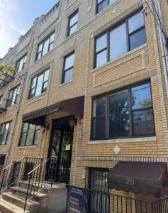 a building on the corner of a street at designer abode condo min to Manhattan in jersey city in Jersey City