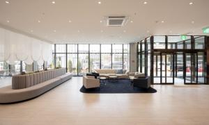 a lobby with couches and chairs in a building at Gyeongju City Hotel in Gyeongju +14 photos