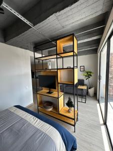 a bedroom with a bunk bed and a television at Apartamento excelente ubicacion in Sogamoso