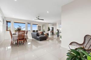 a living room with a couch and a table at Sapphire Magic. in Urunga