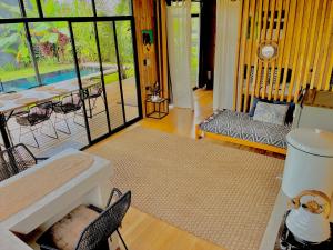 a living room with a table and a couch at Cabaña Grande océan and jungle Infinity swim pool in Santa Teresa Beach +3 photos