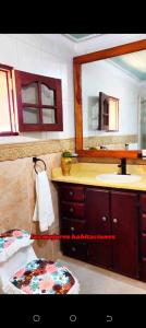 a bathroom with a sink and a mirror at Aparta hotel vista al mar in Río San Juan