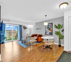 a living room with a couch and a table at Rare find by the Riverside in Windsor