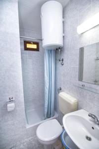 a bathroom with a white toilet and a sink at Apartament Skoko in Slatine +63 photos