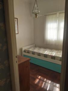 a small bedroom with a bed and a dresser in it at Casa En Punta Mogotes in Mar del Plata