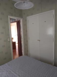 a bedroom with a bed and a door to a hallway at Casa En Punta Mogotes in Mar del Plata +11 photos