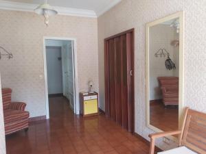 a room with a mirror and a table and chairs at Casa En Punta Mogotes in Mar del Plata