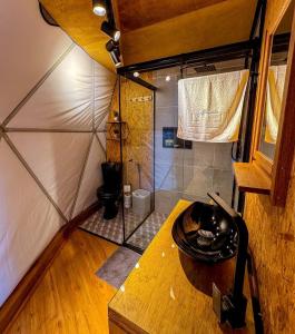 a small bathroom with a shower in a room at Glamping Atmosphera in Cambara do Sul