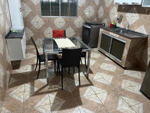 a kitchen with a table and chairs in a kitchen at Casa 6 in Olinda