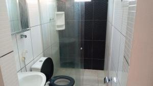 a small bathroom with a toilet and a shower at Casa 6 in Olinda +9 photos