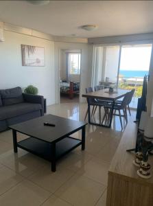 a living room with a couch and a table at Platinum Apartments at Bargara in Bargara