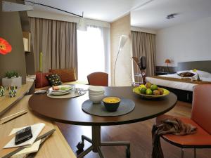 a room with a table with a bowl of fruit on it at Aparthotel Adagio Nantes Centre in Nantes