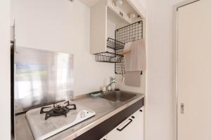 a kitchen with a sink and a counter top at アンドステイ永福3丁目301 in Tokyo +29 photos
