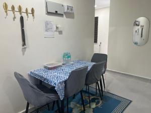 a table in a room with chairs and a table with a table cloth at Homestay Teratak Ainaz in Alor Setar
