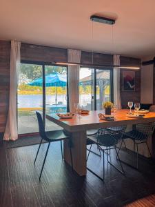 a dining room with a large wooden table and chairs at Waterfront Home with Arcade, MassageChair, Firepit, Infinity Game Table in Rockford