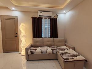 a living room with a bed and a window at Townhouse in Malolos - Ezzy Good Spot in Malolos