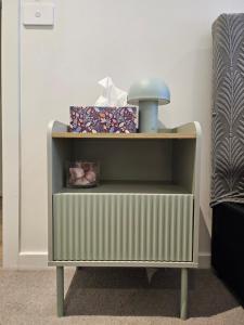 a small green and white cabinet with a light on it at Private Ensuite - Homestay near the Airport in Rockbank
