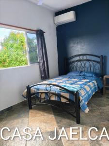 a bedroom with a bed in a room with a window at spacious apartment with ocean view in Brisas de Zicatela