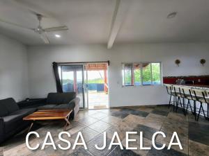 a living room with a couch and a table at spacious apartment with ocean view in Brisas de Zicatela +11 photos