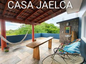 a porch with a hammock on a house at spacious apartment with ocean view in Brisas de Zicatela