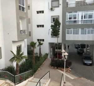 a view of a building with a parking lot at Résidences tazerzit smouna in Agadir