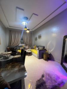 a living room with a couch and a table at Résidences tazerzit smouna in Agadir