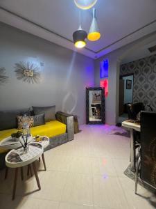 a living room with a couch and a table at Résidences tazerzit smouna in Agadir