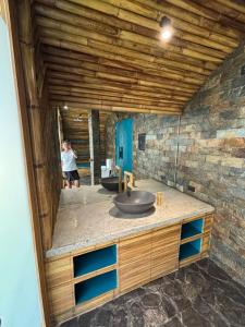 a person taking a picture of a bathroom with a sink at Kenanga Bamboo Villa in Dinalupihan