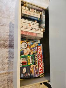 a book shelf filled with books and magazines at Private Ensuite - Homestay near the Airport in Rockbank