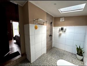 a bathroom with a shower and a toilet in it at Tetebatu flower in Tetebatu