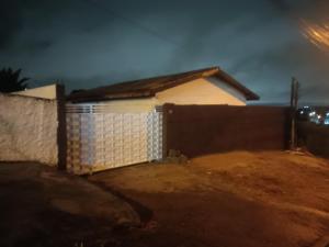 a house with a fence in front of it at night at kitnet in Colombo