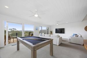 a living room with a ping pong table at Nautilus Rise – Panoramic Bay Coastal Views in Tootgarook
