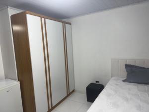 a small bedroom with a bed and a cabinet at kitnet in Colombo