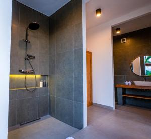 a bathroom with a shower and a sink at KAPI Sebatu Villa in Tampaksiring